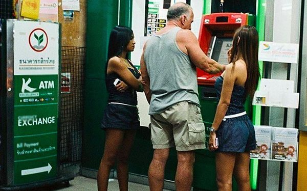 meme man at atm with two thai girls